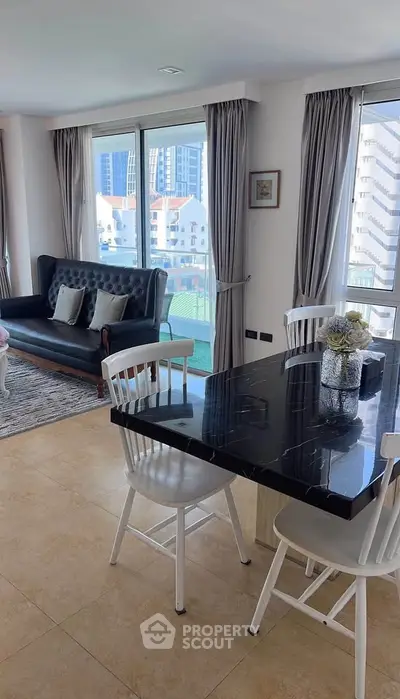 Modern living room with elegant black dining table and city view