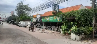 Charming street view with lush greenery and local eateries, perfect for urban living enthusiasts.
