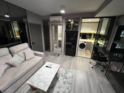 Modern living room with sleek design, open kitchen, and stylish furniture in a contemporary apartment.