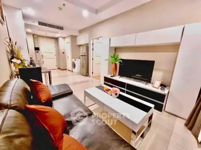 Modern living room with sleek furniture and stylish decor in a cozy apartment setting.