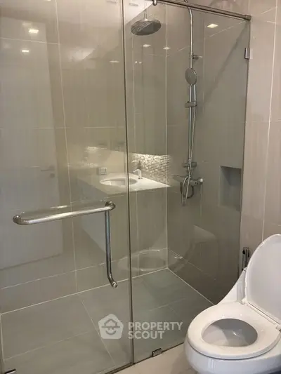 Modern bathroom with glass shower enclosure and sleek fixtures