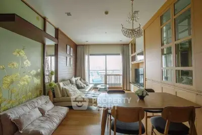 Spacious living room with elegant decor and large window offering natural light and city view.