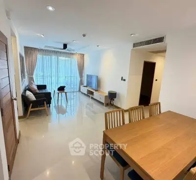 Spacious modern living room with dining area and large windows for natural light.