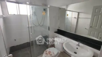 Modern bathroom with glass shower enclosure and sleek fixtures