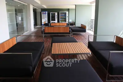 Modern communal lounge area with sleek seating and vending machines, perfect for relaxation and socializing.