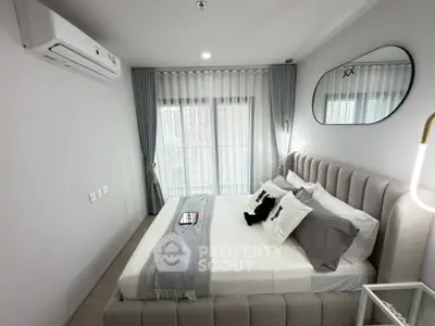 Modern bedroom with stylish decor and natural light, featuring a plush bed and elegant curtains.