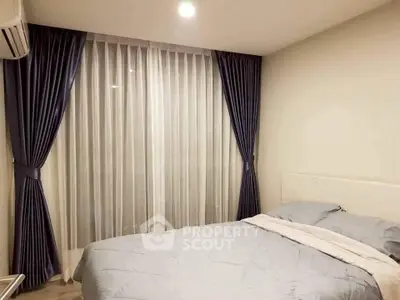 Cozy bedroom with elegant curtains and soft lighting, perfect for relaxation.
