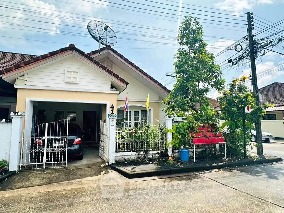 Charming suburban house with driveway and lush garden, perfect for family living.
