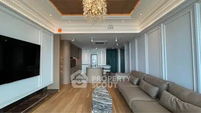 Luxurious living room with elegant chandelier and modern open kitchen layout