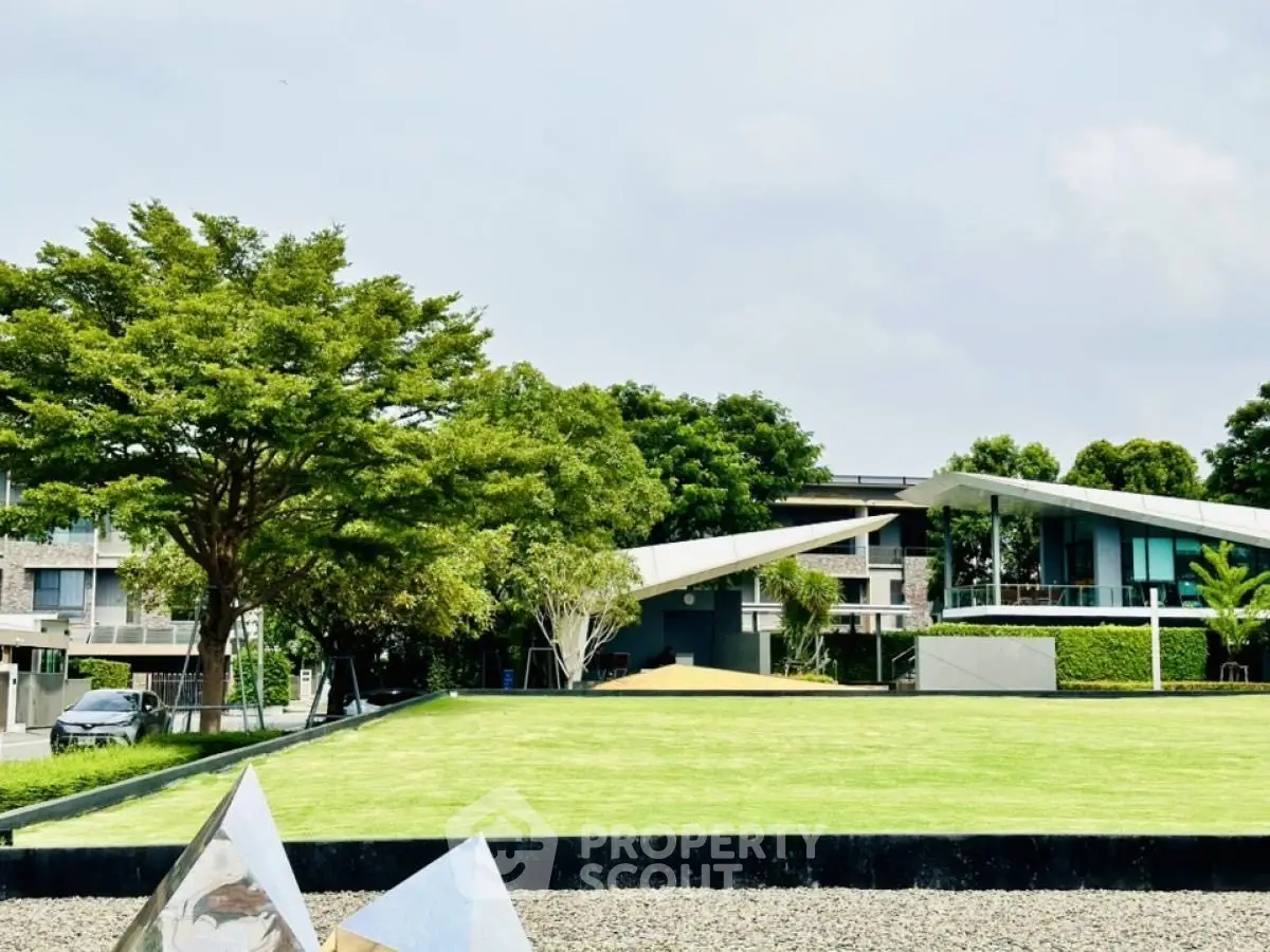 Modern architectural home with lush garden and unique roof design