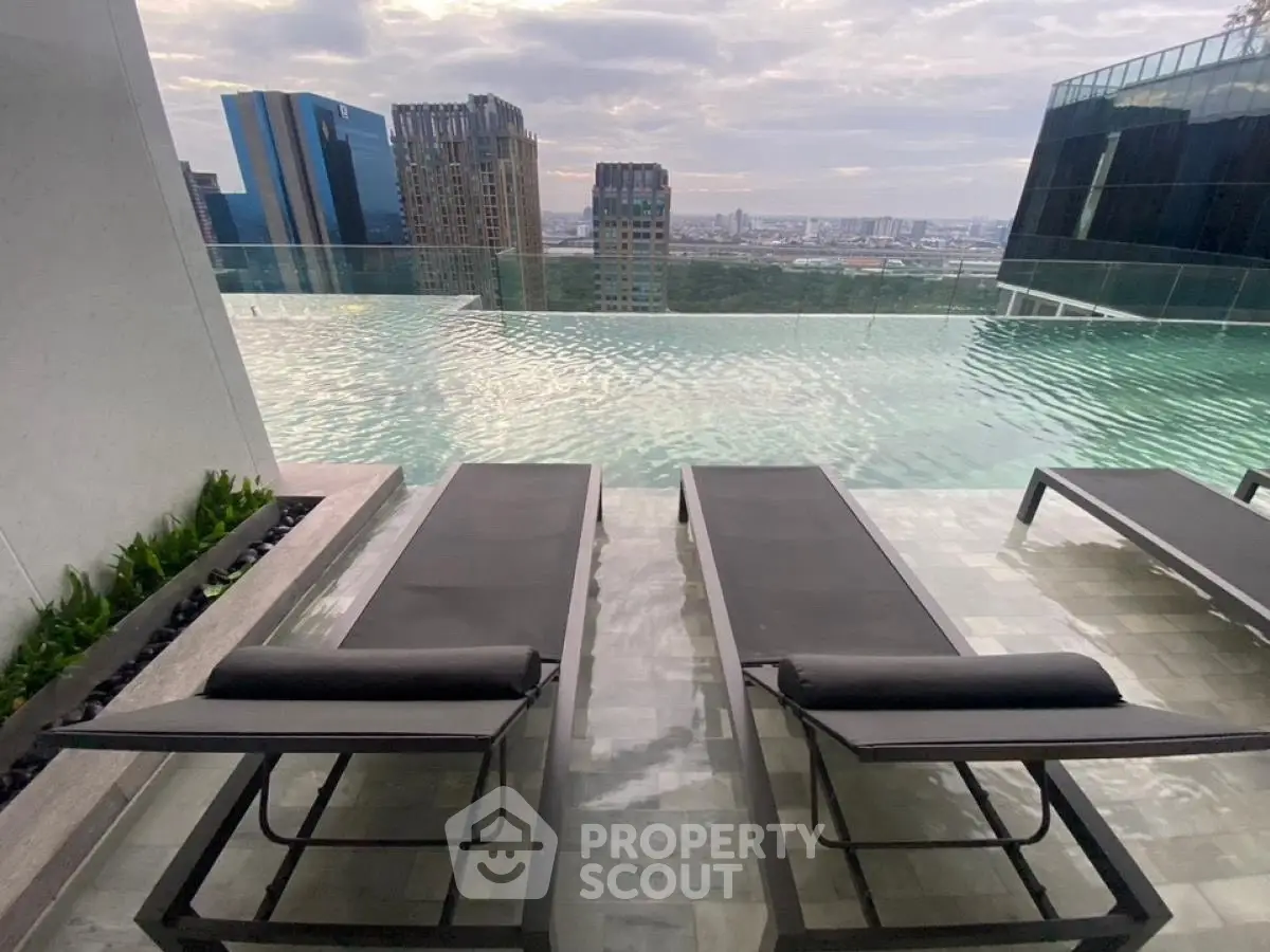Luxurious rooftop pool with stunning city skyline view, perfect for relaxation and leisure.