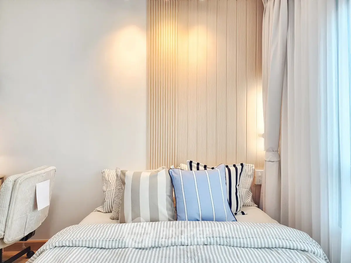 Cozy bedroom with stylish decor and soft lighting, perfect for relaxation.