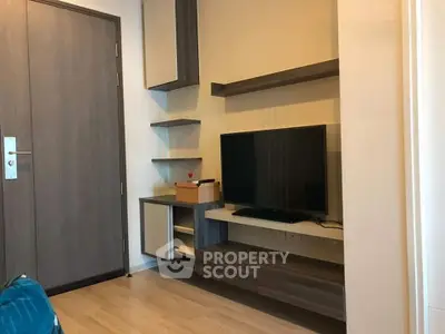 Modern living room with sleek TV unit and wooden flooring