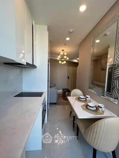 Modern open-layout kitchen and dining area with elegant decor and lighting