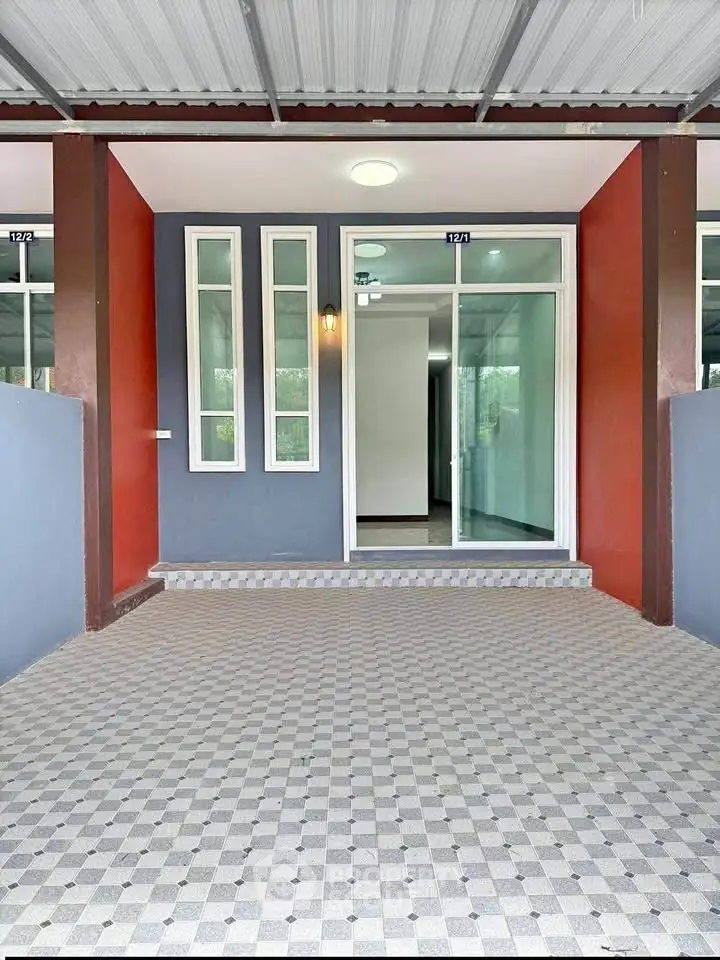 Modern townhouse entrance with stylish facade and checkered tile flooring.