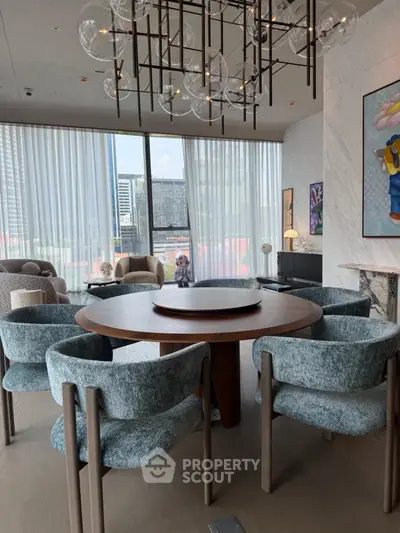 Luxurious modern living room with elegant round dining table and stylish chairs, featuring floor-to-ceiling windows with city view.