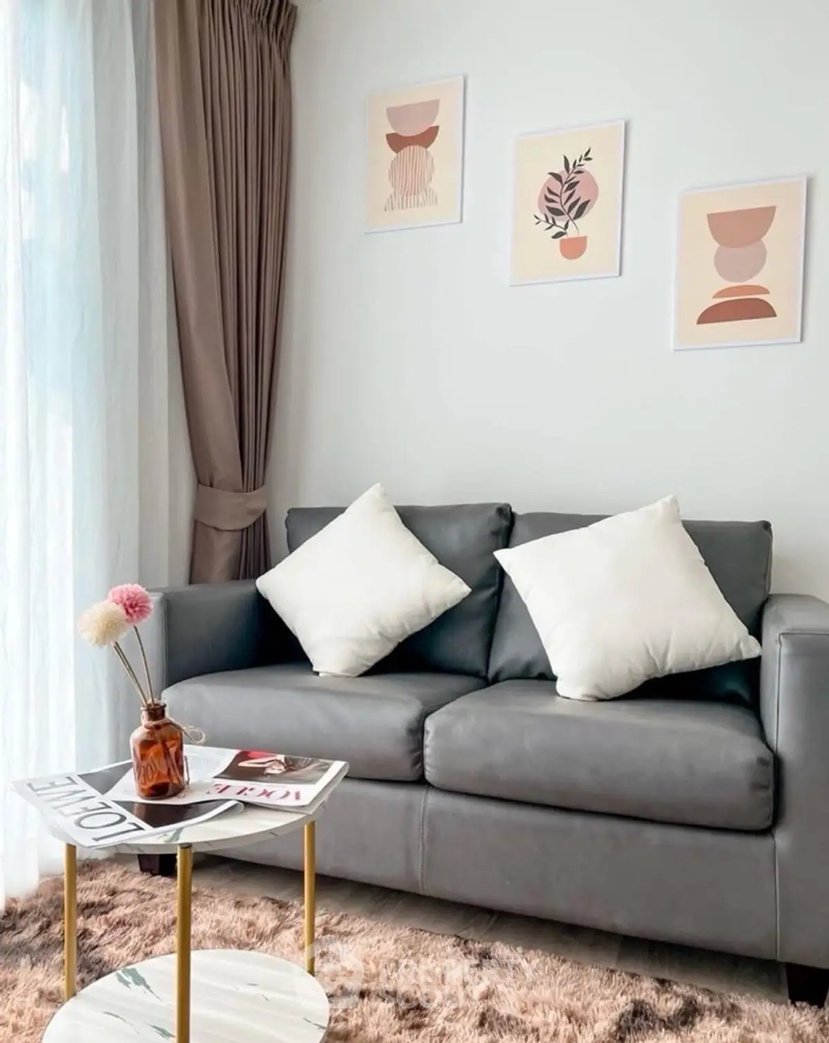 Stylish living room with modern gray sofa, chic decor, and natural light for a cozy ambiance.