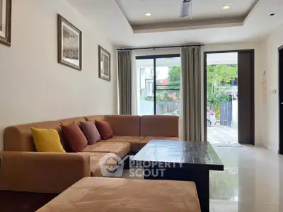 Spacious living room with modern decor and large windows for natural light.