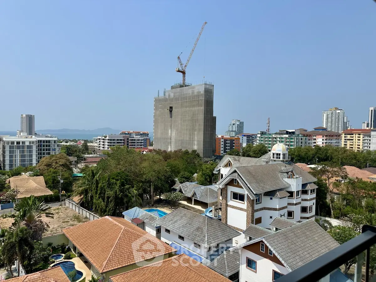 Stunning cityscape view with modern buildings and construction crane, showcasing urban development potential.