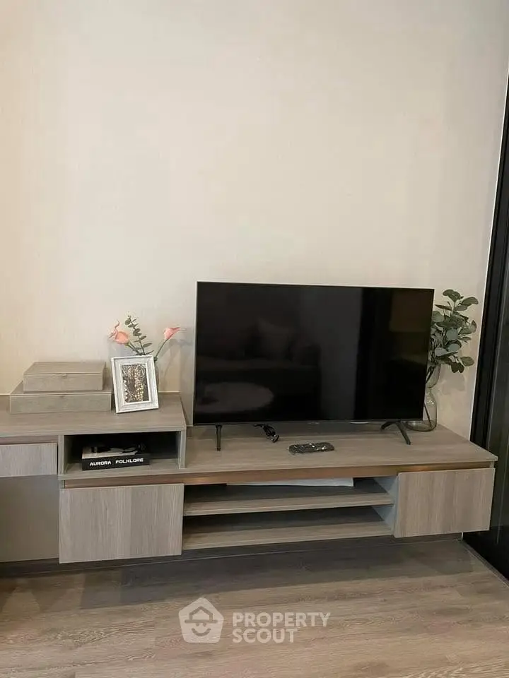 Modern living room with sleek TV stand and flat-screen TV, perfect for entertainment.
