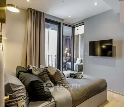 Modern bedroom with balcony access and wall-mounted TV in luxury apartment.