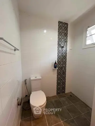 Modern bathroom with stylish tile accent and natural light