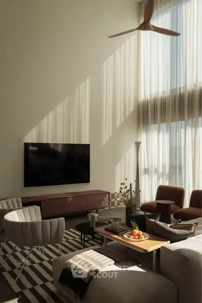 Spacious modern living room with high ceilings, large windows, and stylish furniture.