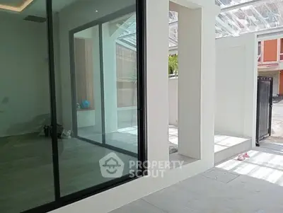 Modern home entrance with glass doors and sleek design