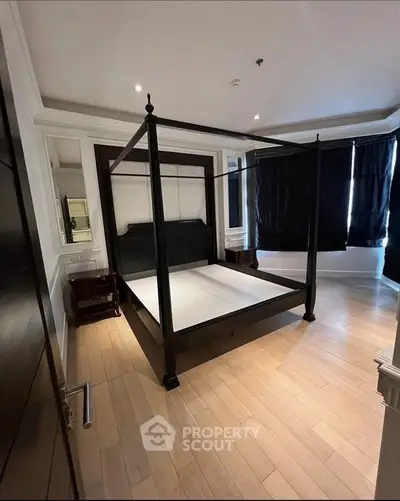 Luxurious bedroom with elegant four-poster bed and hardwood flooring