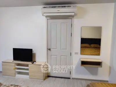 Modern bedroom with air conditioning, TV, and stylish furnishings.