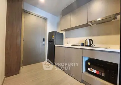 Modern kitchen with sleek cabinetry, compact appliances, and stylish design perfect for urban living.