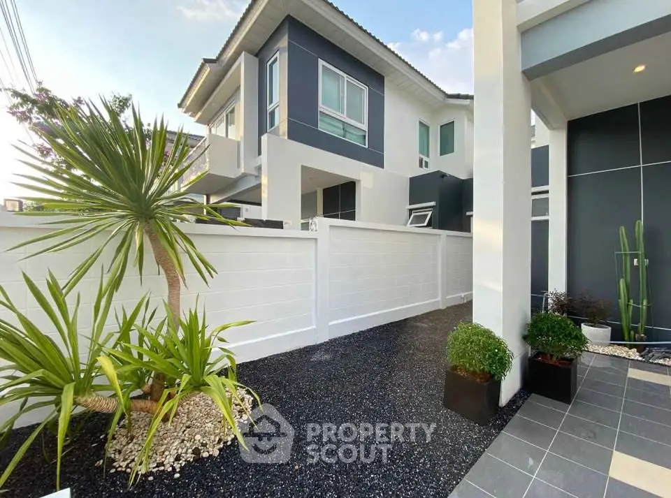 Modern two-story house with sleek design and landscaped garden