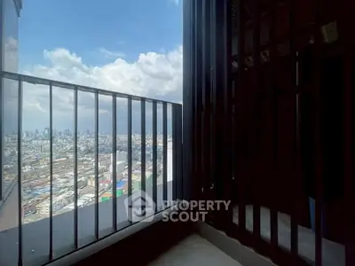 Stunning cityscape view from a high-rise balcony with sleek railing design.