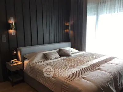 Luxurious bedroom with elegant lighting and plush bedding in modern apartment