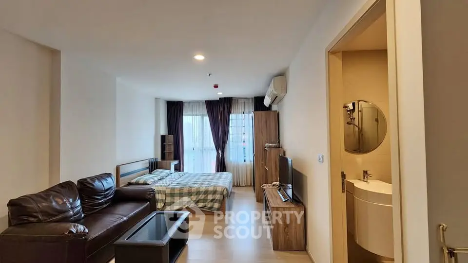 Modern studio apartment with cozy living area and stylish decor