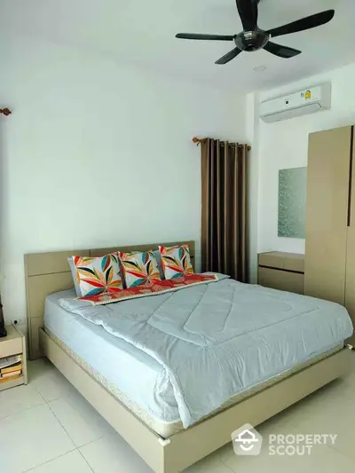 Modern bedroom with stylish decor and air conditioning in a cozy apartment.