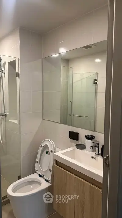 Modern bathroom with sleek fixtures and glass shower enclosure