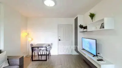 Modern living room with sleek furniture and wall-mounted TV, perfect for cozy gatherings.