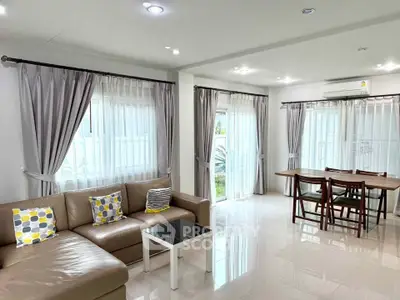 Spacious living room with modern decor and ample natural light