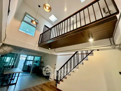 Spacious modern interior with high ceilings and stylish lighting in a contemporary home.