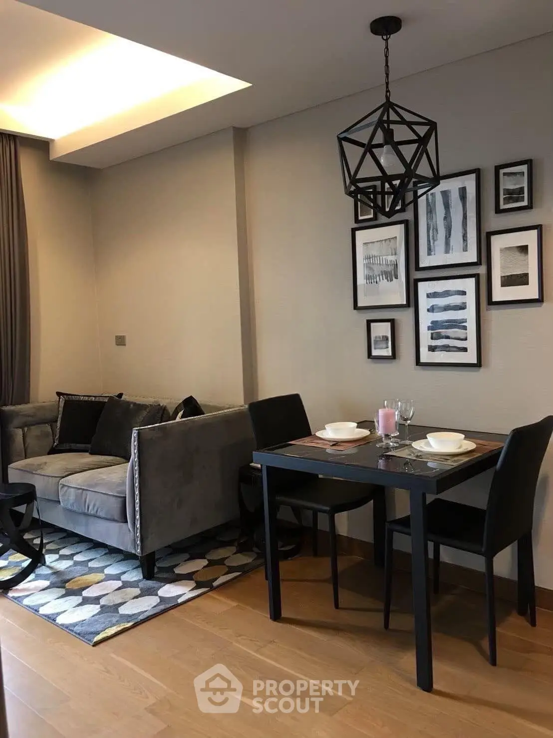 Modern living room with stylish decor and dining area in a cozy apartment.