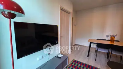 Modern living room with wall-mounted TV and stylish dining area