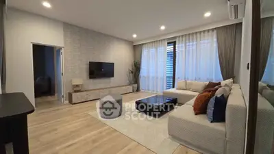 Modern living room with stylish decor and large windows for natural light.