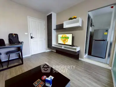 Modern living room with sleek furniture and wall-mounted TV in stylish apartment.