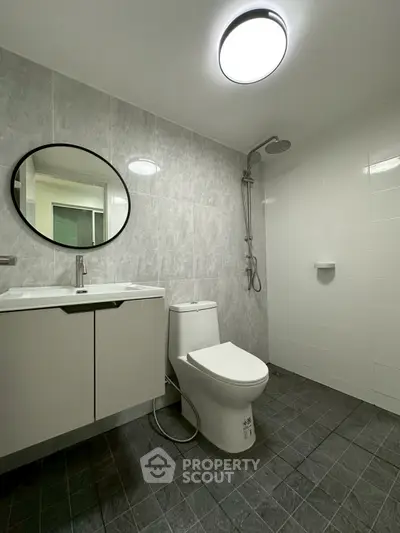 Modern bathroom with sleek fixtures and a spacious shower area.