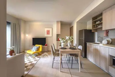 Modern open-plan living room and kitchen with stylish decor and natural light.