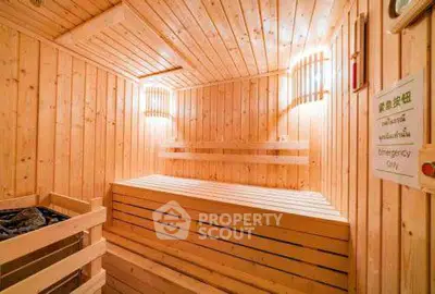 Luxurious wooden sauna room with warm lighting and seating benches.