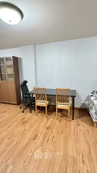 Spacious study area with wooden flooring and modern furniture