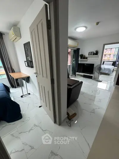 Modern apartment interior with marble flooring, cozy living room, and bedroom view.