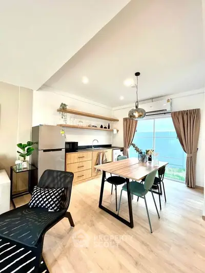 Modern open-plan kitchen and dining area with stylish decor and natural light.